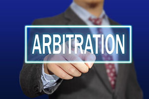Man in Suit Pointing to Arbitration Sign