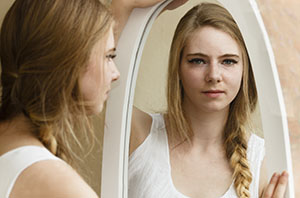 Woman looking in the mirror
